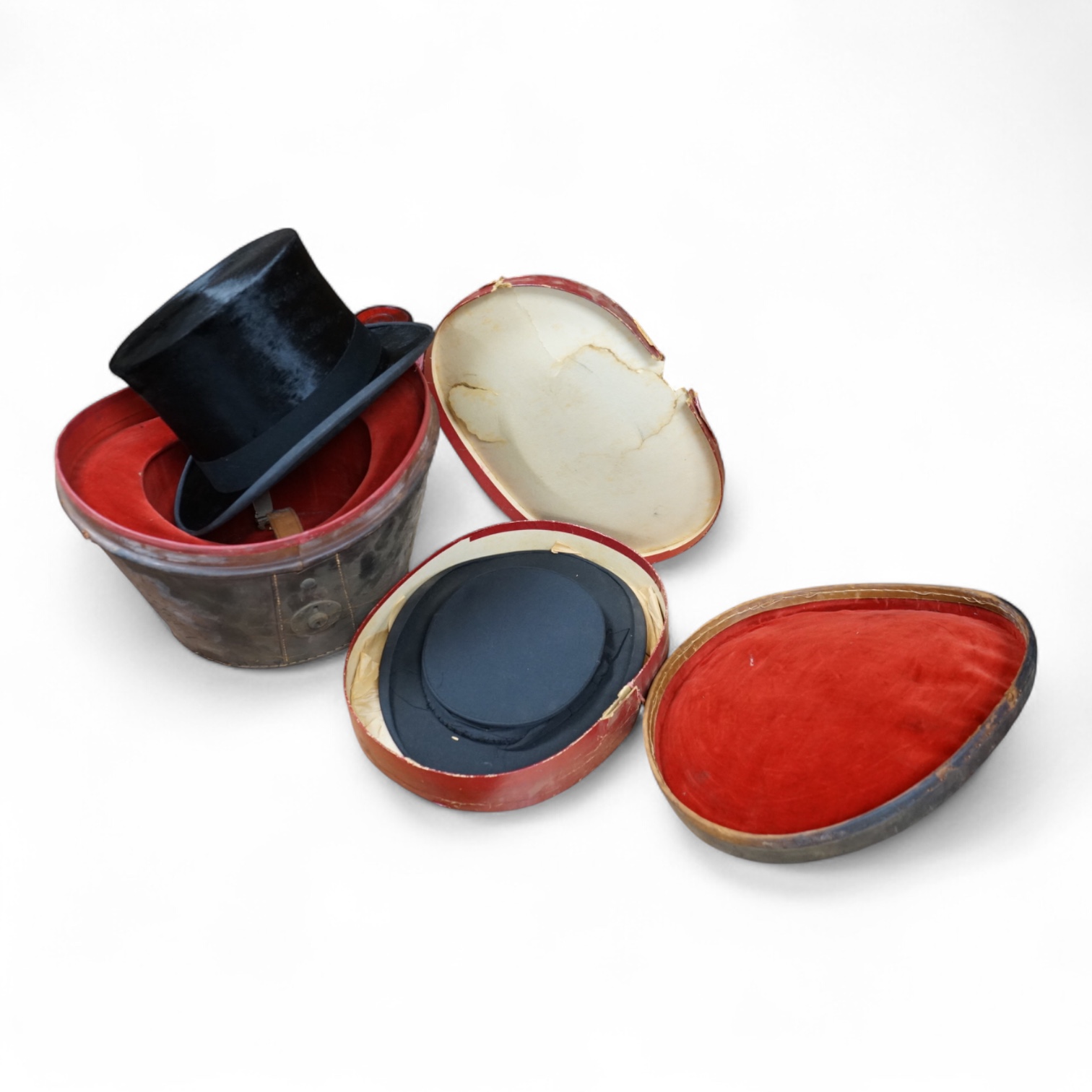 A black brushed silk top hat by Lincoln Bennett, Bond Street, London, in leather case with red velvet lining, together with a collapsible boxed top hat. Brush top hat size, approximately 21 inches. Condition - brushed si
